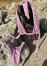 Load image into Gallery viewer, Pink and white patterned bikini on a rock