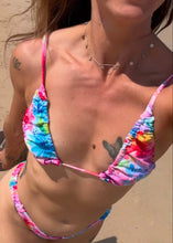 Load image into Gallery viewer, A close-up of a triangle string bikini top with a multicolor tie-dye pattern, featuring thin straps and a ruched design.