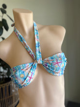 Load image into Gallery viewer, Blue bikini top with starfish pattern on a mannequin against a neutral background