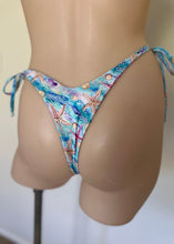 Load image into Gallery viewer, Colorful bikini bottom with starfish design on a mannequin against a neutral background