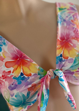 Load image into Gallery viewer, Colorful floral bikini top on a mannequin with a blurred background