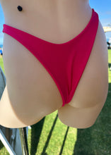 Load image into Gallery viewer, Person wearing a red bikini bottom with a blurred background