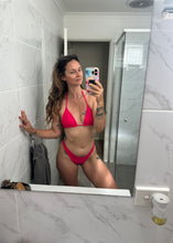 Load image into Gallery viewer, Person taking a mirror selfie wearing a pink bikini in a tiled room.