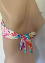 Load image into Gallery viewer, Colorful floral bikini bottom on a mannequin against a neutral background

