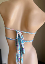 Load image into Gallery viewer, Mannequin wearing a floral bikini with a blurred background
