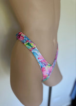 Load image into Gallery viewer, Colorful floral thong on a mannequin against a neutral background
