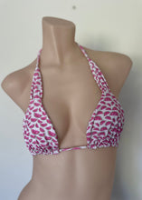 Load image into Gallery viewer, Pink and white patterned bikini top on a mannequin against a plain background
