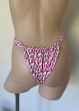 Load image into Gallery viewer, Mannequin wearing a pink and white patterned bikini bottom against a plain background
