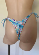Load image into Gallery viewer, Colorful bikini bottom with starfish pattern on a mannequin against a neutral background

