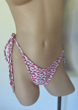 Load image into Gallery viewer, Mannequin wearing a pink and white patterned bikini bottom on a plain background
