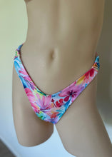 Load image into Gallery viewer, Colorful floral bikini bottom on a neutral background
