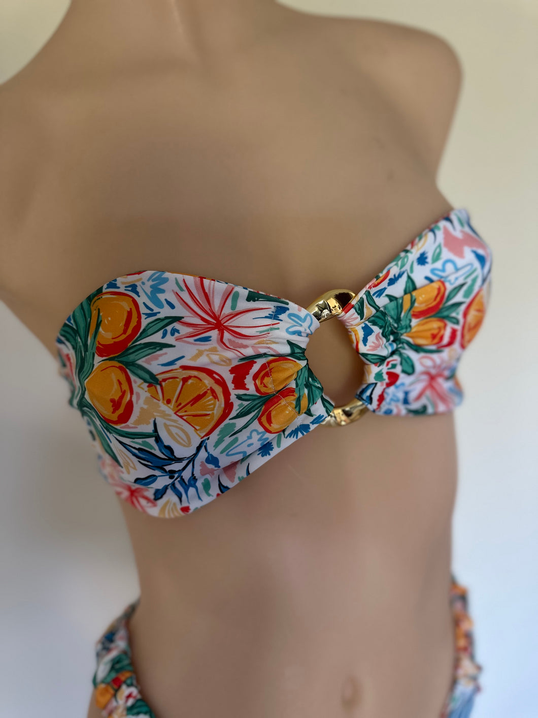 Floral bikini top on a mannequin with a white background