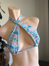 Load image into Gallery viewer, Colorful starfish-patterned bikini top on a mannequin against a neutral background
