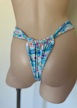 Load image into Gallery viewer, Multicolored bikini bottom on a mannequin against a plain background

