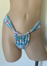 Load image into Gallery viewer, Multicolored bikini bottom on a mannequin against a neutral background
