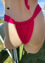 Load image into Gallery viewer, Mannequin wearing a bright pink bikini top with a blurred outdoor background
